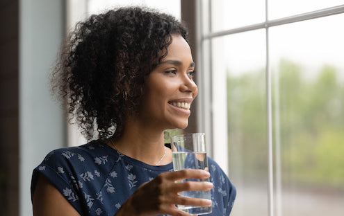 https://www.qualitywaterforless.com/cdn/shop/files/bigstock-Smiling-African-American-Woman-390222914_Edit_5110ebed-ebcb-4a8c-be99-d36a744fe731.jpg?v=1614296713